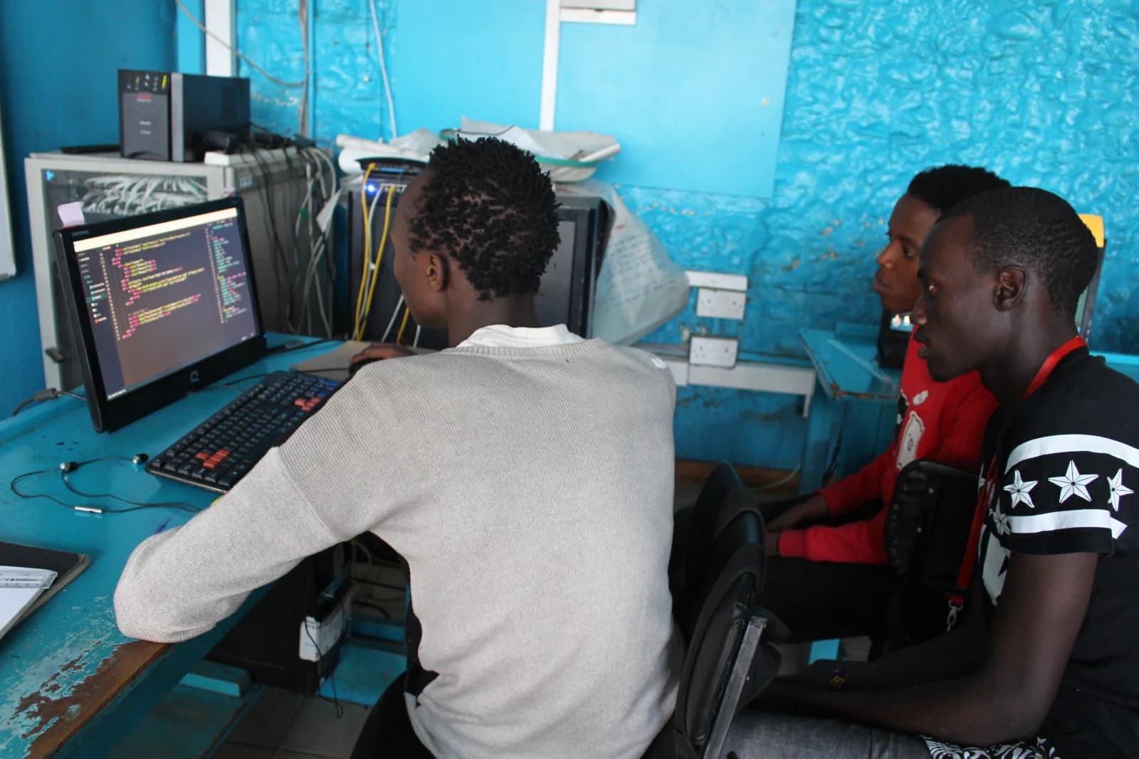 NairoBits students writing code together at a community computer lab in Nairobi