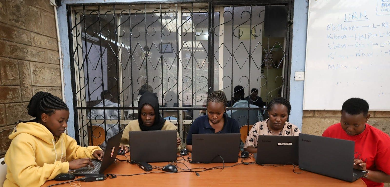 Students working on laptops in a NairoBits training lab